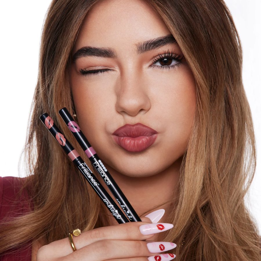 The Frilliance × Embreigh Lip Kit, held up beside a wink